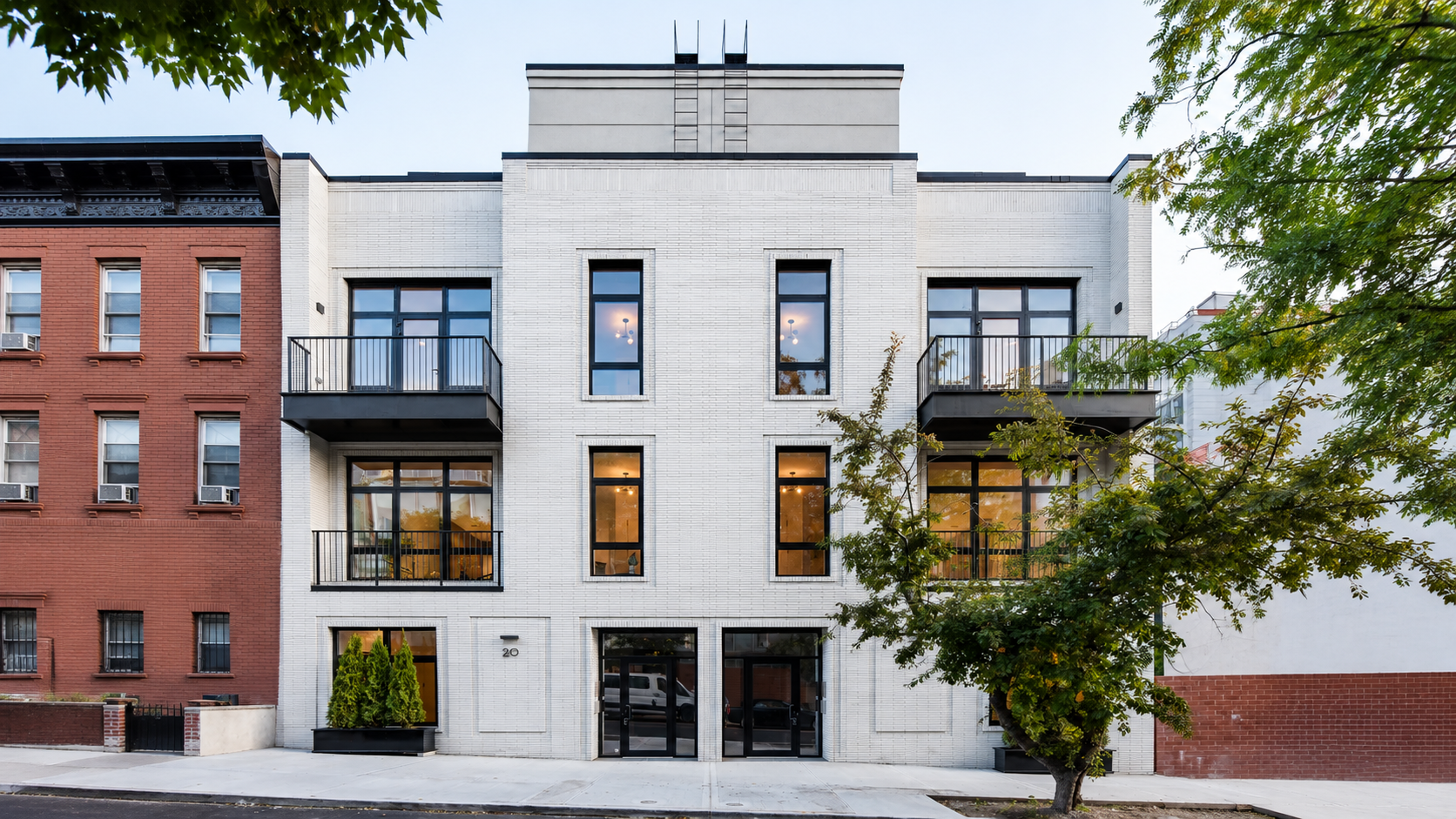 Renovated townhouse at 20, light brick facade